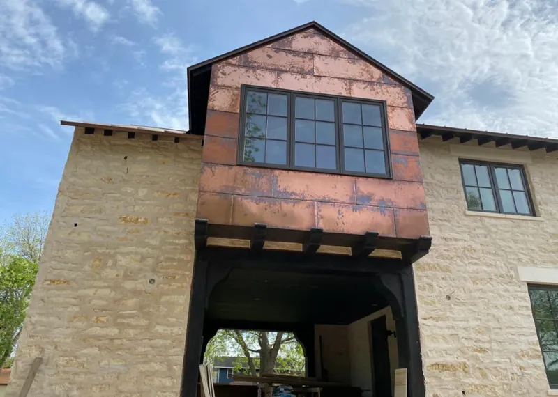 Copper metal panel facade on a stone building for Skylight Installation in Lake Jackson