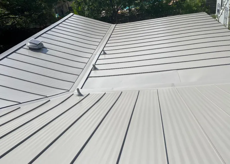 Solar attic fan installed on a metal roof for Roof Ventilation in Lake Jackson